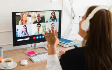 Student attending to an online class wearing a white pair of headphones