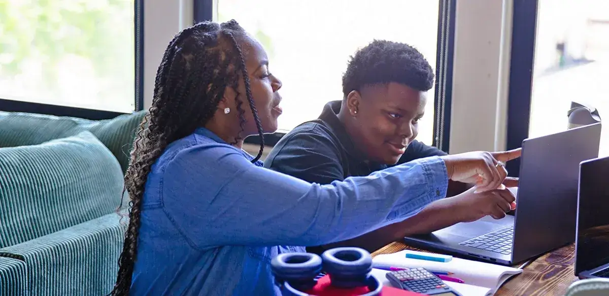 Mother and son working with their laptop